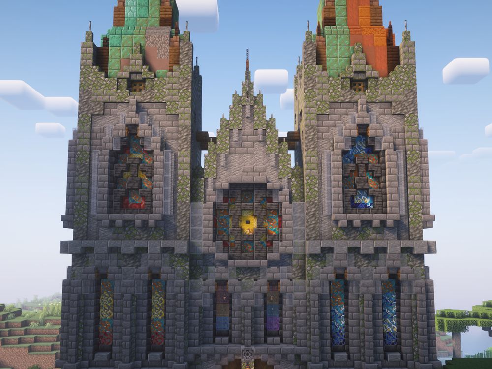 Minecraft screenshot of a cathedral from the front, with colorful stained glass and a rose window in view.