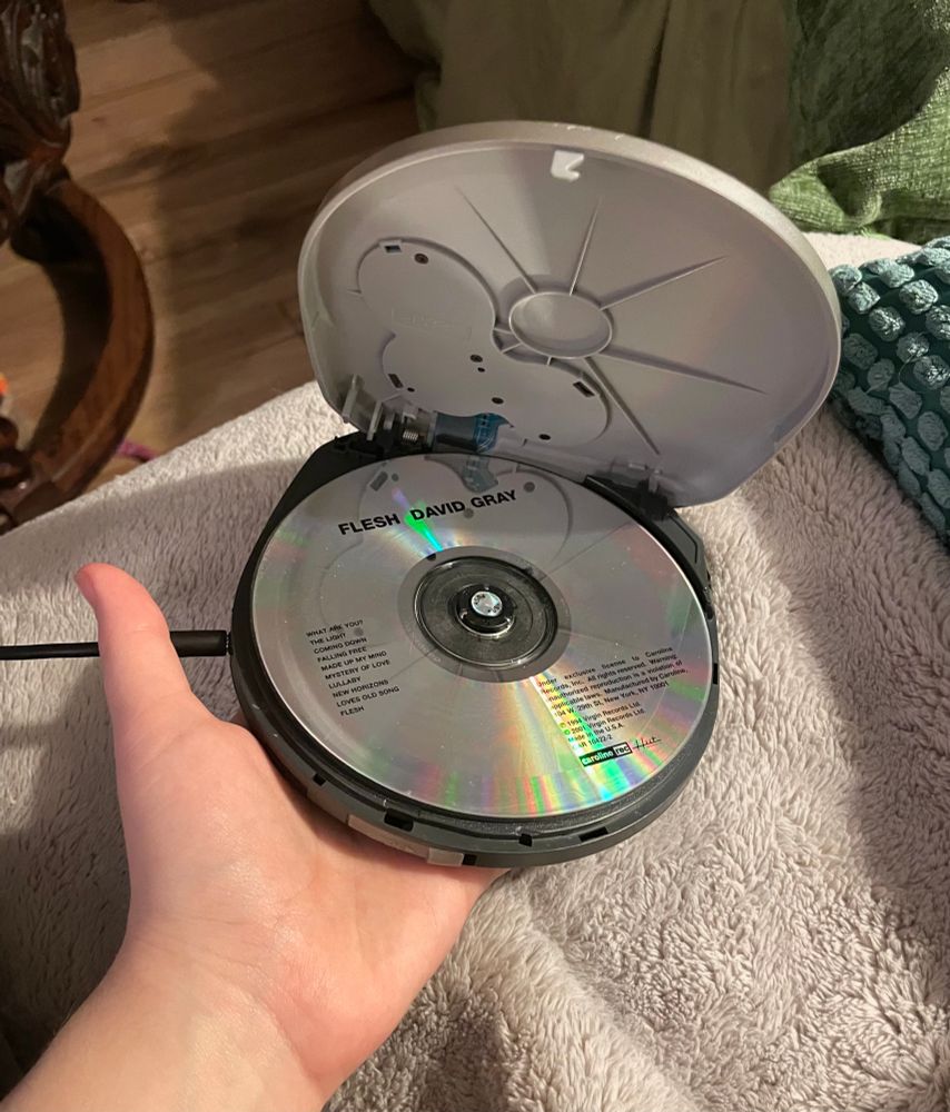 2001 release of Flesh by David Gray sitting in a panasonic portable CD player