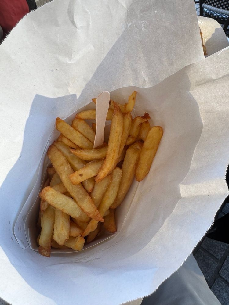 Photo of a portion of fries in a paper bag 