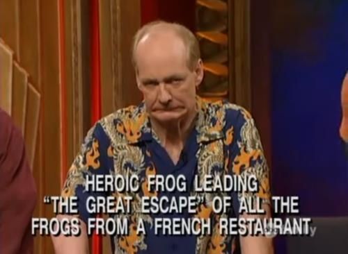 A screenshot of Colin Mochrie making a face with the text "Heroic Frog Leading 'The Great Escape' of All the Frogs from a French Restaurant"