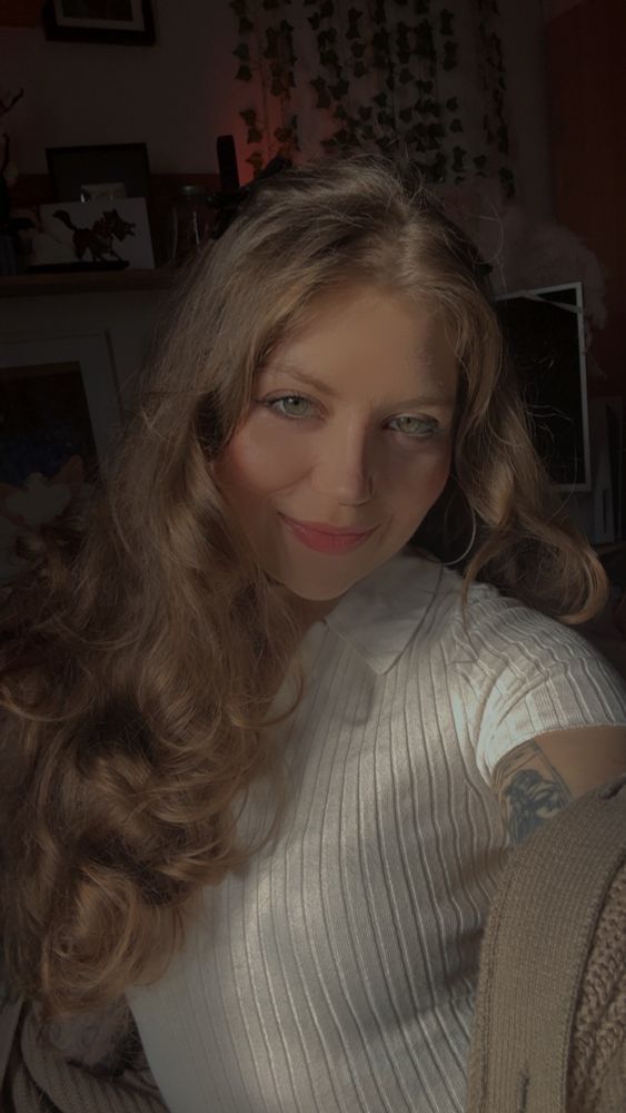 Me in a white collared top and sweater. 