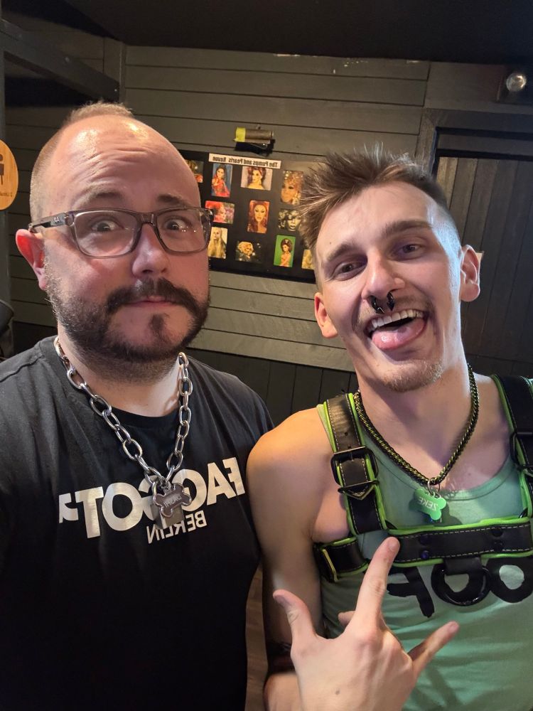 Faust and Zeke posing at a bar