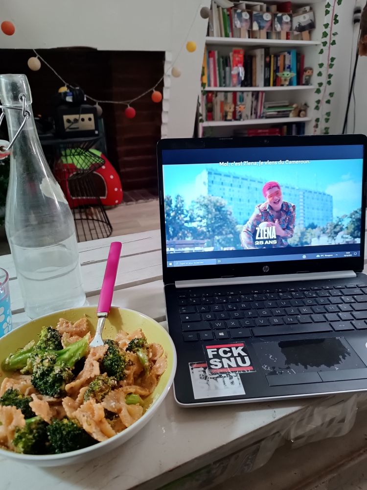 Nouvelle école sur mon profil et pâtes aux brocolis pesto rosso dans une assiette à côté, tout sur la table basse