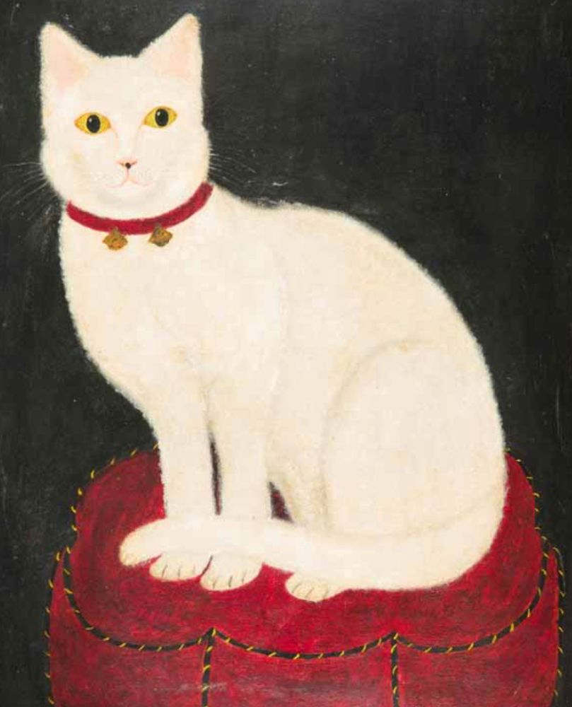 Folk art style oil pinging of a shorthaired white cat with yellow eyes and a red collar with two gold bells on it. It is sitting up on a red cushion or ottoman and the background is black.