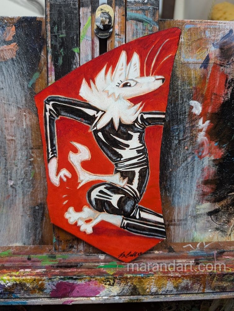 An irregular shape of thick leather with a cartoon white coyote dressed in tight black latex painted on it