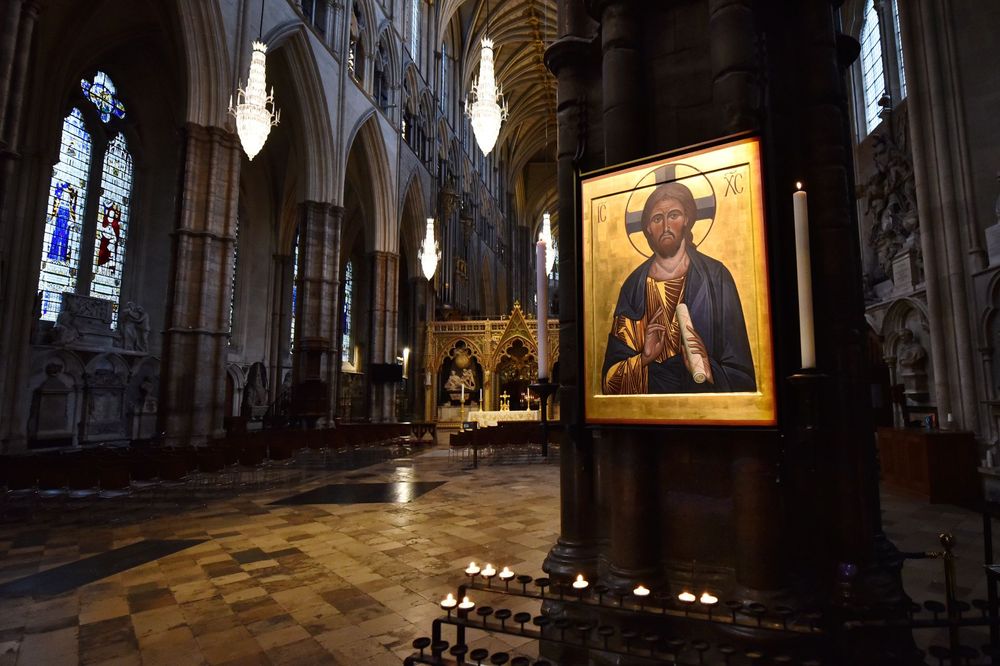 The nave of Westminster Abbey, with a framed icon of Christ on a pillar in the foreground