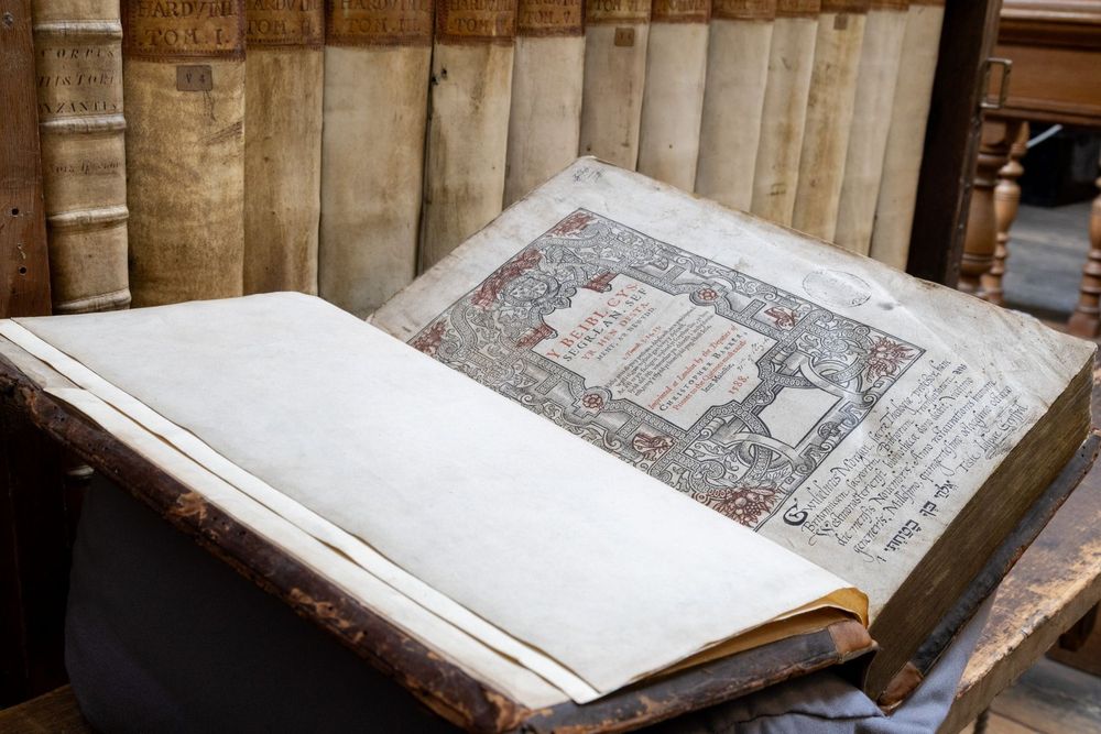 A large copy of a Welsh-language edition of the Bible, opened at its title page, in a library