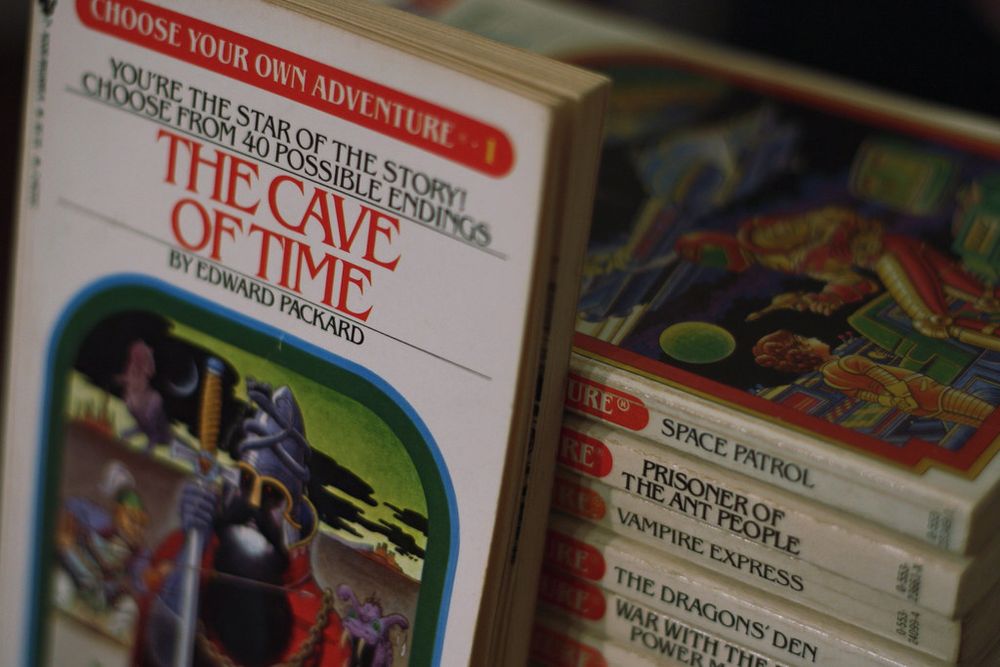 Stack of “Choose Your Own Adventure” paperbacks, with “The Cave of Time” displayed prominently in front.