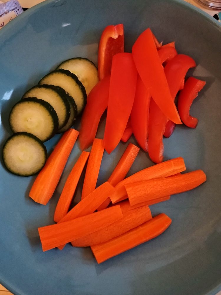 A's dinner tonight: a blue bowl with sliced red capsicum, some cucumber and carrots