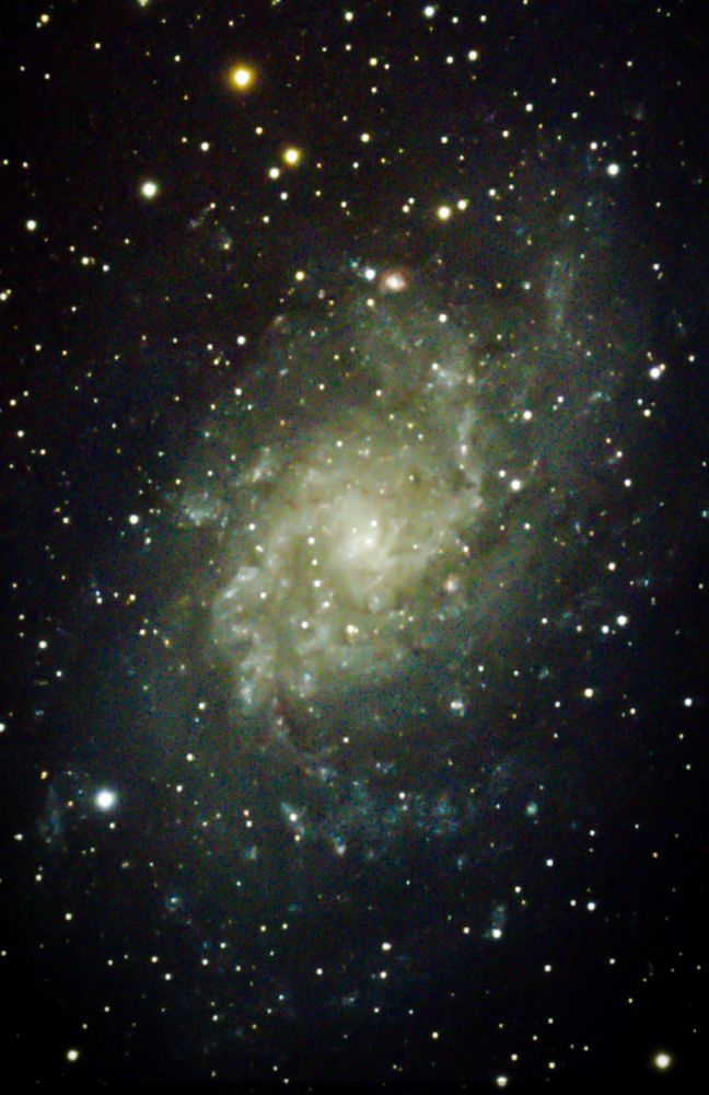 A spiral galaxy, the Triangulum Galaxy, through an astrophotography telescope.