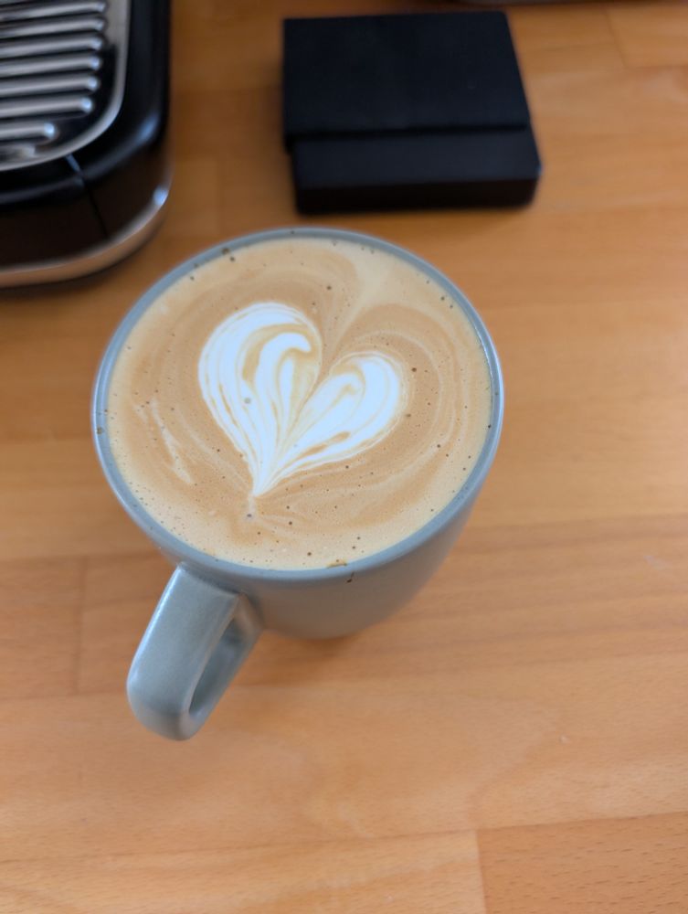 Latte with a heart in a green cup