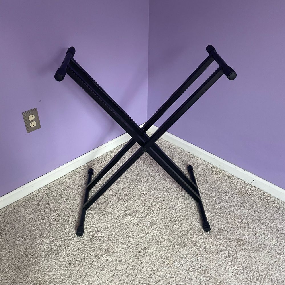 A stand for a keyboard piano that looks remarkably similar to the Twitter “X” logo