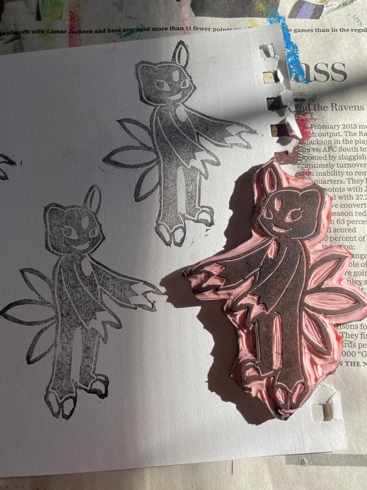 A linocut stamp of the Pokemon Sneasel, with it stamped on the page it’s on twice in black.