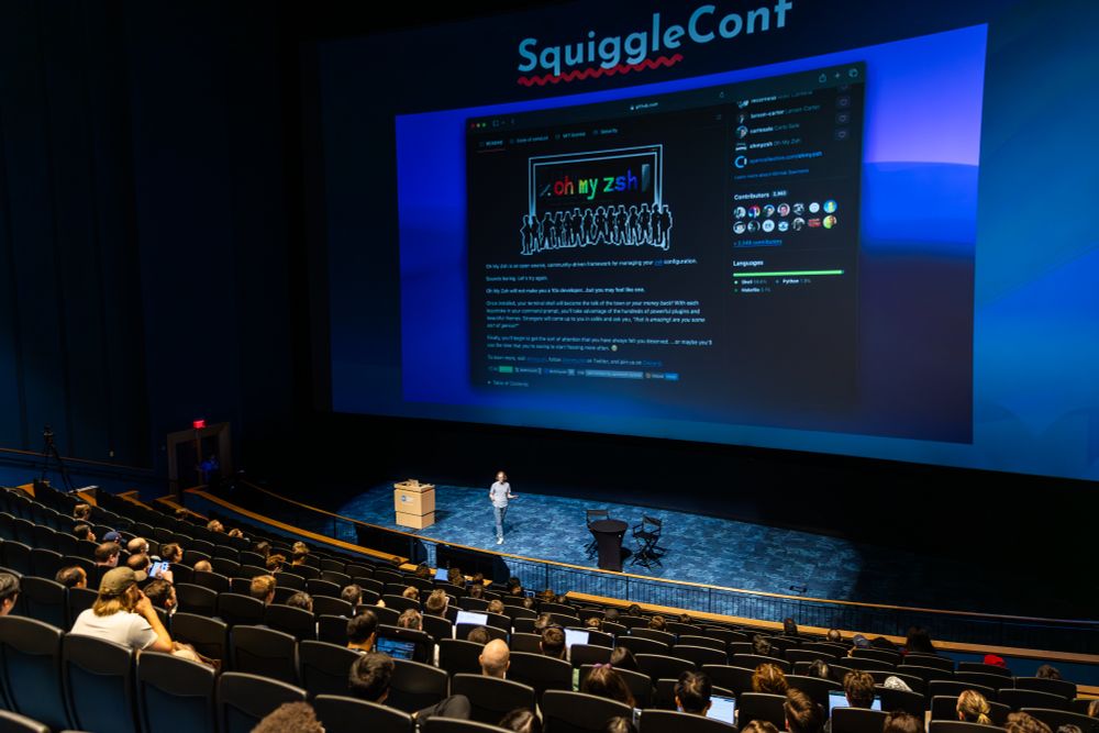 Robby Russell giving a talk about Oh My Zsh on stage at the New England Aquarium IMAX theater.