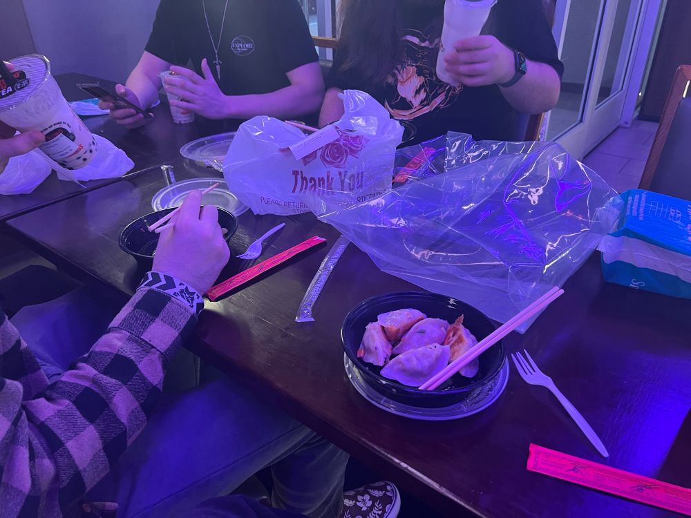 A picture of me and friends eating dumplings in Chinatown