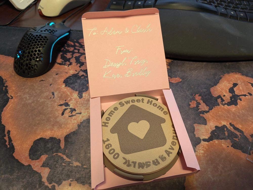 A set of four coasters in a pink box