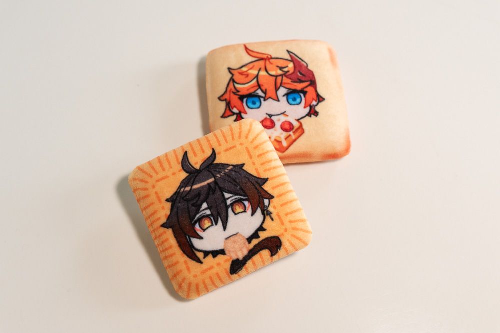 product image of 2 plush badges featuring Tartaglia and Zhongli from the game Genshin Impact - Zhongli is the badge in the front