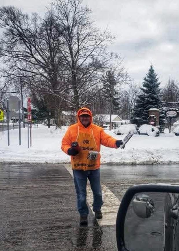 Man selling papers in the road