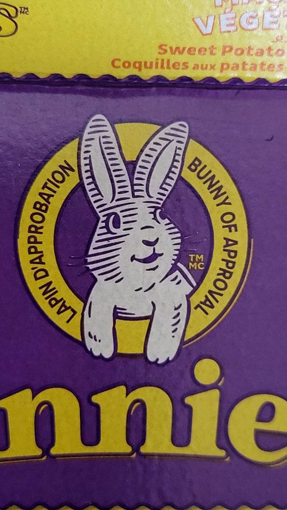 Close up of the Annie's logo which includes a smiling cartoon rabbit and the phrase bunny of approval in French and English.