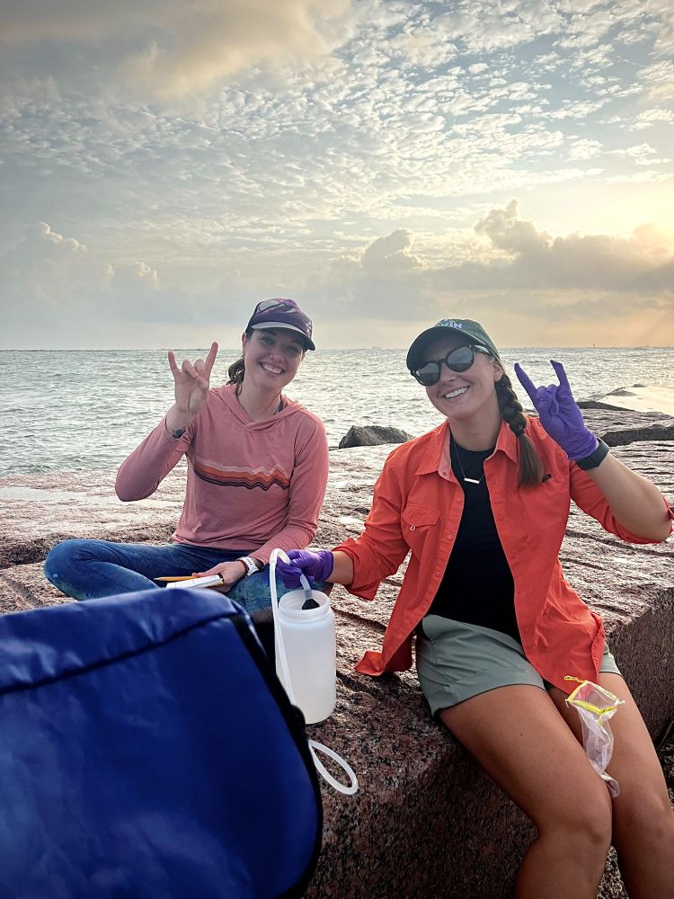 PhD students Hannah Rempel and Christina Marconi filter seawater to sample environmental DNA and record water quality data on the Texas Coast.