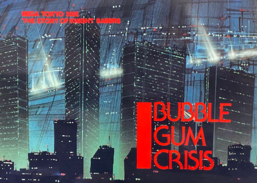 The title card of the 1987 anime Bubblegum Crisis. The title is red and behind it is the skyline of a futuristic cyberpunk city. 