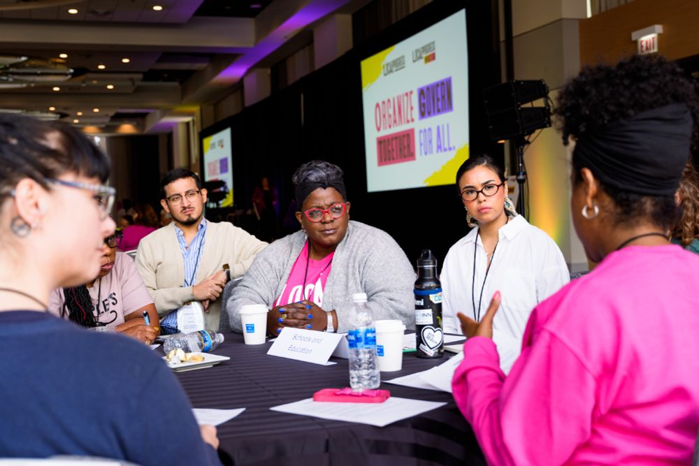 A group of people talking at a table