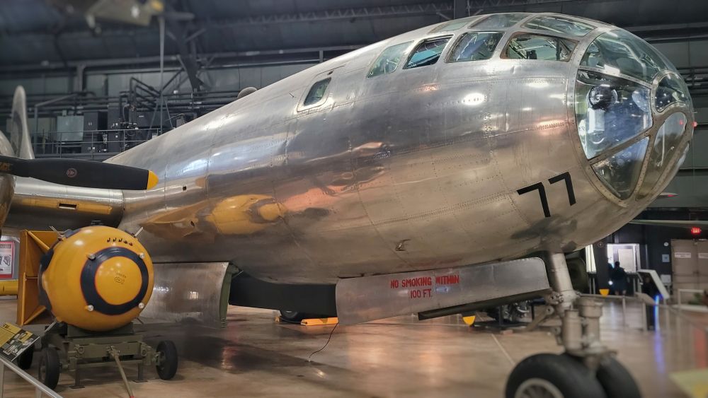 The nose of Bockscar, the B-29 that dropped the second atomic bomb on Nagasaki. The fuselage is a round cylinder, with bare aluminum skin. The nose is greenhouse of small windows.
Next to it is a full scale replica of Fat Man, the bombbomb that was dropped. You can see from its size that it barely fits in the bomber, despite it's large size. 