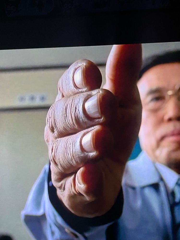 Screencap of man reaching out to intitiate a handshake in the movie Mr.Vengeance