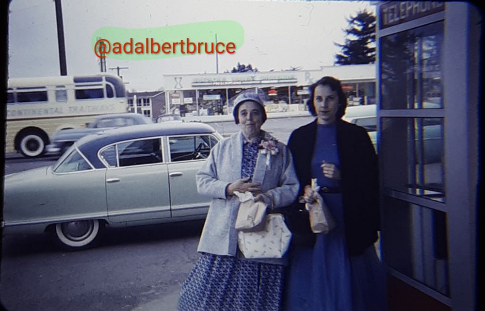 My great-aunt Magda Lenox, and my mother, standing by a telephone booth. A classic 1950s car is in the background. -JBF 