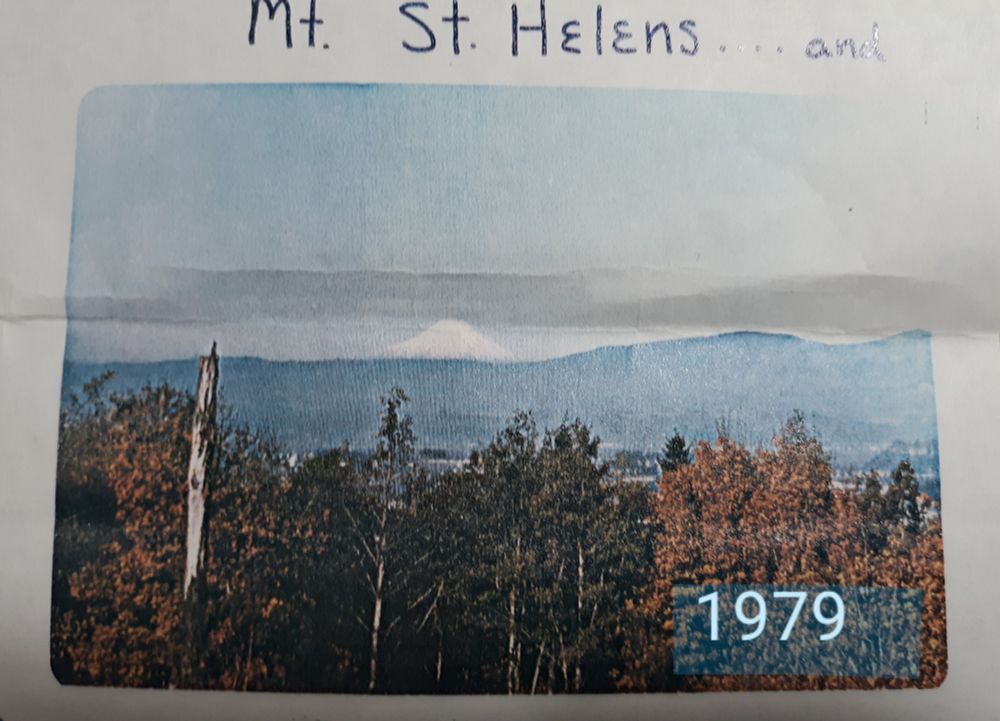 Mt. St. Helens, seen on the horizon, not long before its May 18,1980 eruption (snow-capped, still conical, with autumn trees in the foreground).