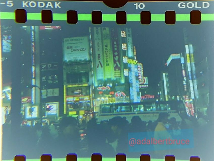 A street view of crowded streets, and stacks of neon signs, at night in 1995 Tokyo. -JBF 