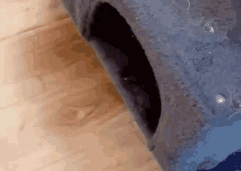 a close up of a hole in a blue object