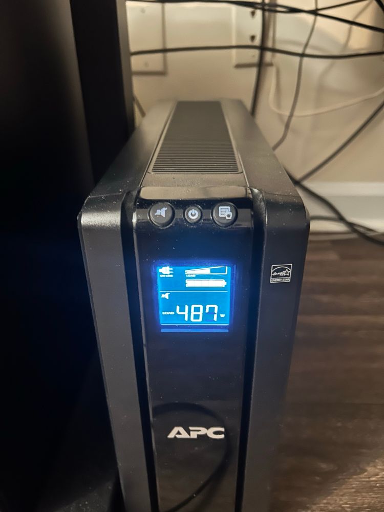A UPS (Uninterruptible Power Supply) displaying a 487 watt load.