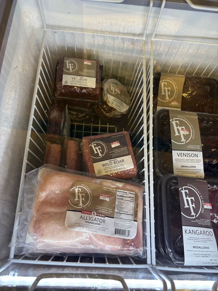 selection of less common meats in a grocery store fridge. Venison, as well as wild boar and alligator featured  