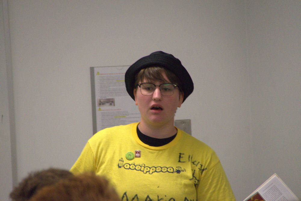 Marie-Ange (wearing glasses, yellow shirt and black bucket hat)