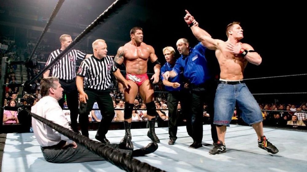 Royal Rumble 2005. John Cena pointing in the air with two SmackDown refs and two Raw refs with Batista in the middle staring at him as Vince McMahon sits against the ropes with two torn quads.