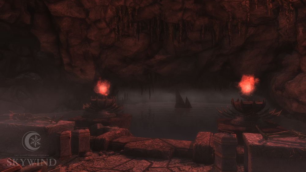 Picture from inside Ibar-Dad, featuring a section of the cave filled with water. On pillars in the water are two lit braziers, and from the cave ceiling hangs stalactites. 