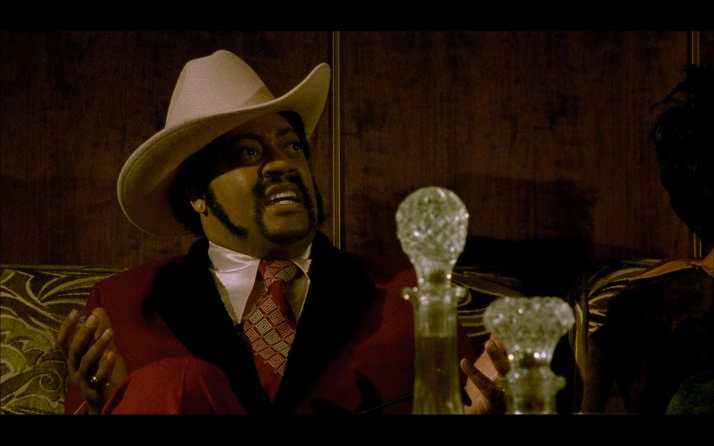 A pimp in a cowboy hat who's just been told that Black Dynamite is going to war with anyone who sells drugs to the community.
