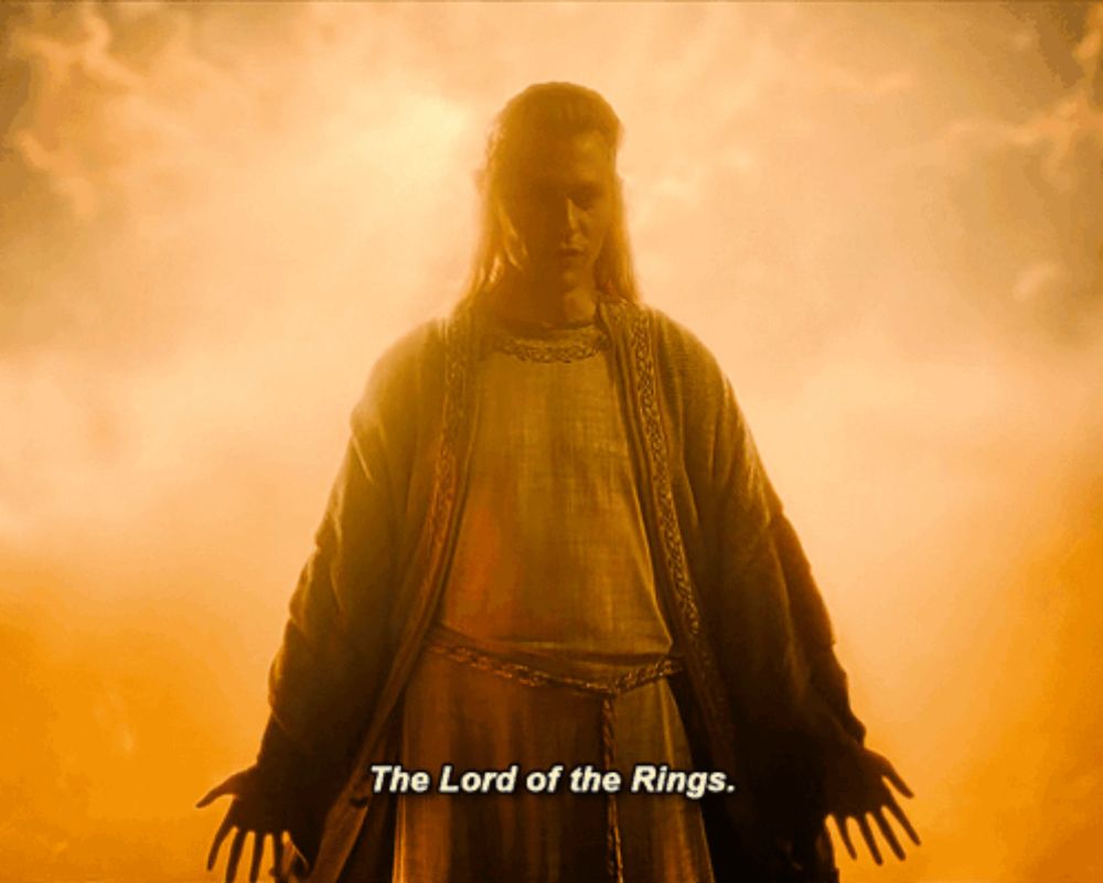 a man in a robe with the words " the lord of the rings " below him