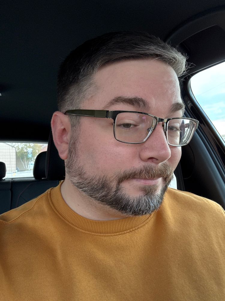 White dude in glasses with a fresh haircut.