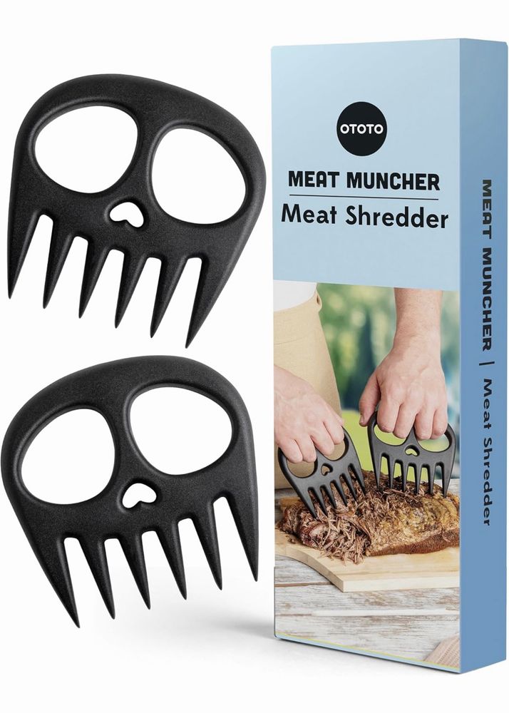 Two black skull-shaped meat shredders next to a box labeled “OTOTO Meat Muncher Meat Shredder.”