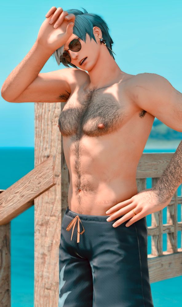 Granson stands, shirtless with Moonfire trunks and sunglasses, hand to his forehead as he’s sweating.