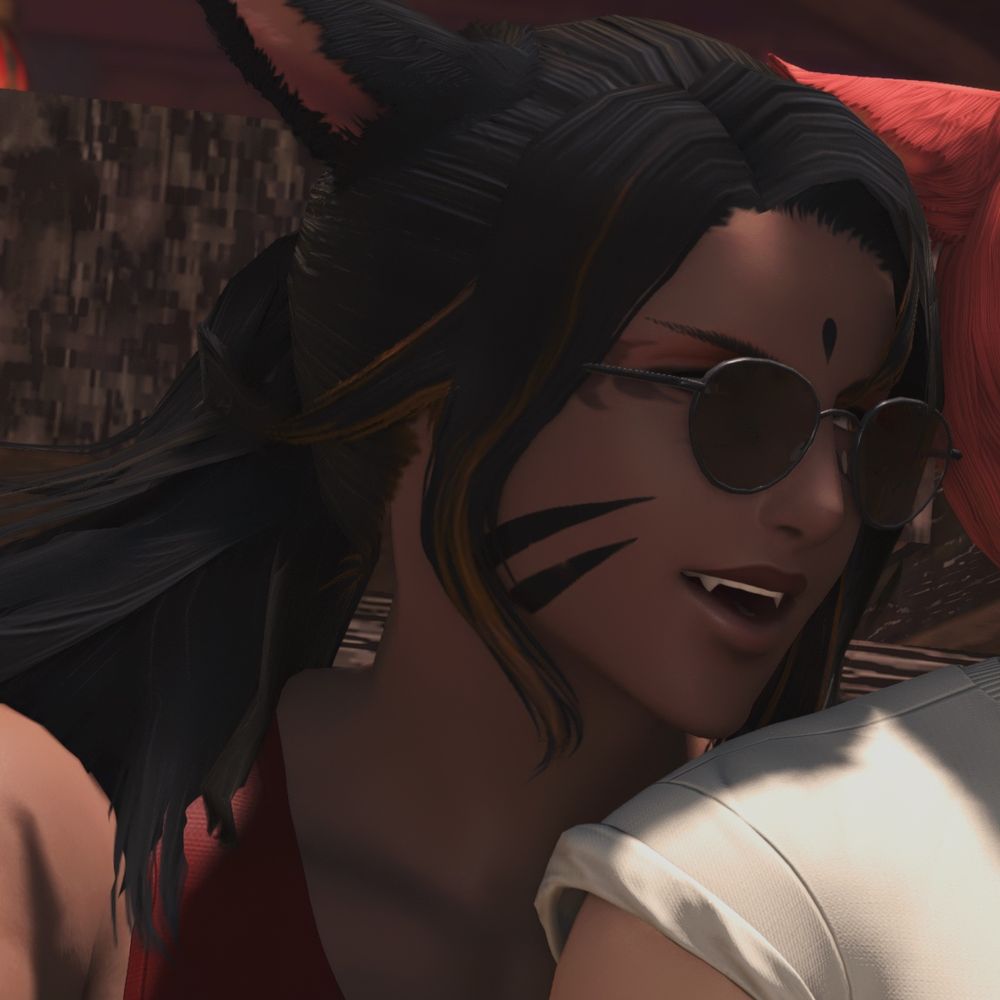 Orion smirking, sunglasses on and looking over G’raha’s shoulder.