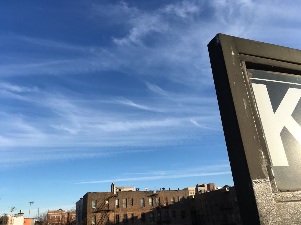 A blue skyline with part of a sign with a K.