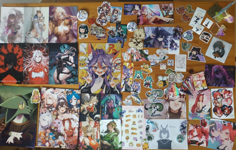 first row (kinda):
Hex Maniac, Satsuki and Seras from @cutesexyrobutts.bsky.social 
button from the_magic_carp
Yuki sticker from @yeougui.bsky.social 
Falin and Milia from @ouncemilia.bsky.social 
stickers from @spukycat.bsky.social 
postcard from @rinreearts.bsky.social 
button from @kizuseirei.bsky.social 
wooden Letha standee from @kizuseirei.bsky.social  and @yunarra.bsky.social 
Postcard and keychain from @yunarra.bsky.social 
stickers from @nogoranz.bsky.social, chromie, andy_o7, @forgedfire.bsky.social, chRieks and @smokinxiii.bsky.social 
Frieren book standee and regional Ado sticker from @greenmst.bsky.social 
bottom left corner:
Signalis and Isa from @baloolax.bsky.social 
WawaLisa and sticker from @paradesii.bsky.social 
community art from @momotexx.bsky.social 
center:
lenticular art, postcards, bookmark and stickers from @littlemisstina.bsky.social 
stickers from @tiwicat.bsky.social 
bottom right corner:
stickers from Yoshino and @saachichu.bsky.social 
card from @deathchill.bsky.social 
stickers from @nebbigraphy.com @naiichie.bsky.social  and @omgbees.bsky.social 
postcard from @timjackmaster.bsky.social 
sticker postcard and noodle Letha from @kleeneseumel.bsky.social 
art from @takaocafe.bsky.social 
keychains from @kreyper.bsky.social @ryodw.bsky.social @deminded.bsky.social 
button from @krtaki.bsky.social 
cards, postcards and stickers from @yumiyay.bsky.social 