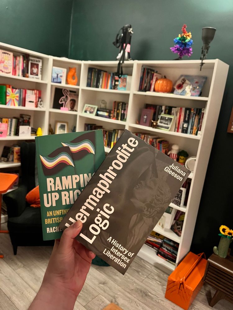 A coup of hermaphrodite logic and ramping up rights in front of a white bookcase 