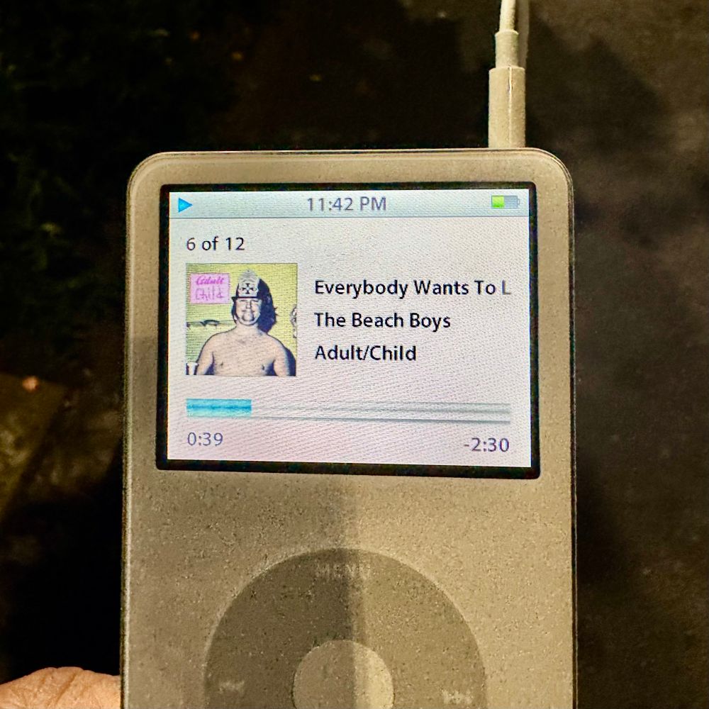 A photo of an iPod playing “Everybody Wants To Live” by The Beach Boys on the album, “Adult/Child”, an unreleased album