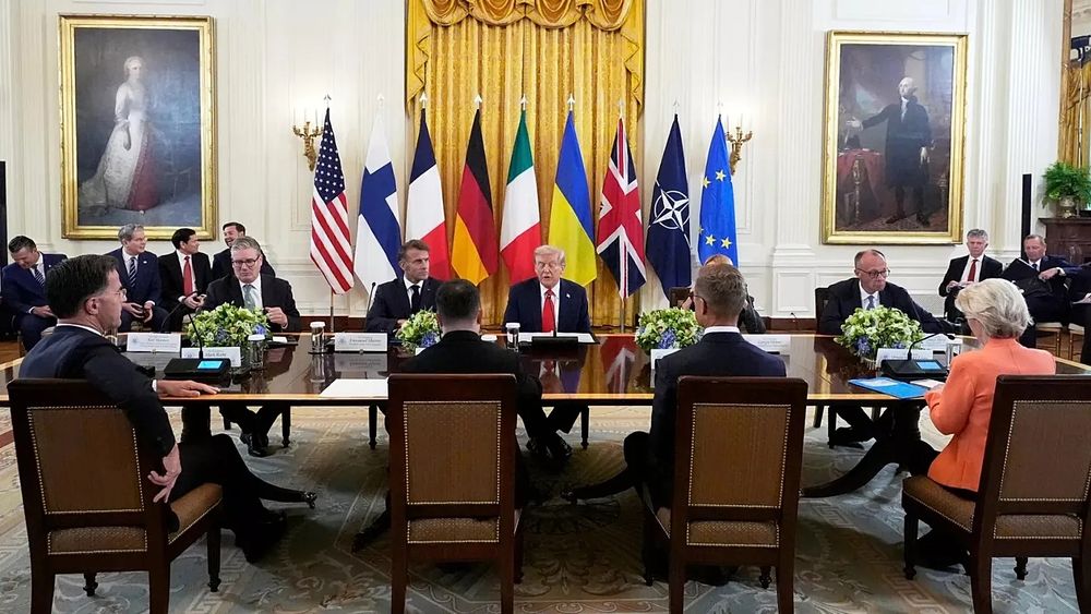 Table gathering of European leaders with Zelenskyy and Trump. In the background JD Vance giggles as he hates Europe.