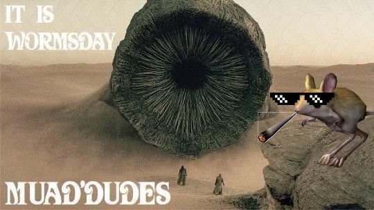A dune meme with a giant sandworm towering over 2 Fremen in the desert. A cool Muad'Dib mouse is overlooking the scene from a cliff, wearing deal-with-it sunglasses and smoking a joint. The text reads “it is wormsday muad'dudes."