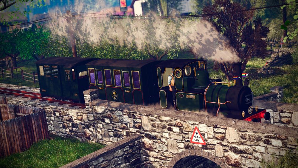 Gwlith chuffing across Gaori Road Bridge on her way toward Little Coverston, Sporting her pride flags and headboard.